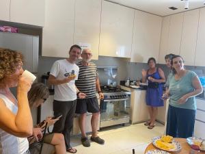 a group of people standing in a kitchen at House of Nomads - Hostel in Muscat
