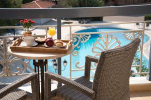 a tray of breakfast food on a table on a balcony at Acharnis Kavallari Hotel Suites in Athens