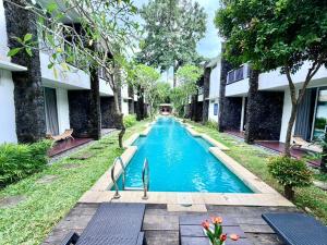 a swimming pool in the middle of a building at Dealton Hotel Sanur in Sanur +20 photos