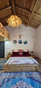 a bedroom with a large bed with a chandelier at Tatsaaraa Kavan in Rāmgarh