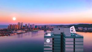 a view of a city at sunset at Sea Cruise Hotel in Sokcho