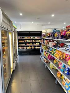 a store aisle of a grocery store with food at Tropical Resort with balcony overlooking pool in Westcourt