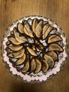 a chocolate cake on a glass plate on a table at Agriturismo Cascina Maiocca in Mediglia