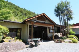 a house with a table and chairs in front of it at Fukuichi in Nambu
