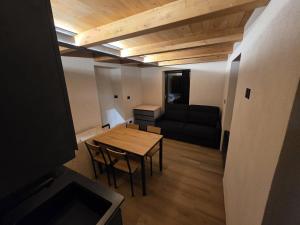 a living room with a table and a couch at Muranche Lofts N1 in Valtournenche