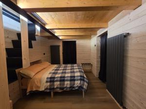 a bedroom with a bed in a wooden room at Muranche Lofts N1 in Valtournenche +8 photos