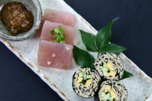 a plate of food with sushi and a piece of watermelon at Fukuichi in Nambu