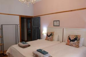 a bedroom with two beds and a chandelier at Hannah's Haven in Beaufort West