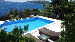 a swimming pool with a view of the water at Villa Vesna Private Beach in Okrug Donji