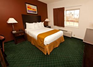 a hotel room with a large bed and a window at Landmark Inn Fort Irwin in Fort Irwin +24 photos