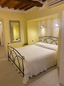 a bedroom with a large bed with white sheets at Gaia's Apartment in Pistoia