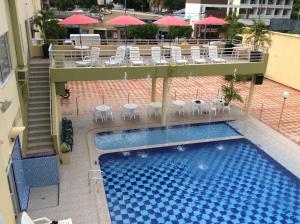 梅爾加的住宿－Hotel Marux Plaza，享有带桌椅的游泳池的顶部景致