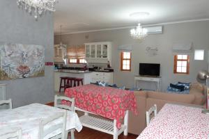 a kitchen and living room with a table and a couch at Hannah's Haven in Beaufort West