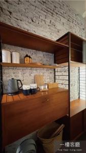 a wooden shelf with dishes on it in a kitchen at Light Room in Tainan