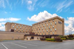 a hotel with a parking lot in front of it at Radisson Hotel Philadelphia Northeast in Trevose
