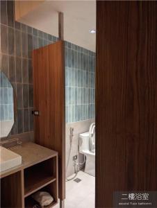 a bathroom with a sink and a toilet at Light Room in Tainan +7 photos