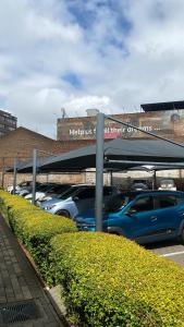 a parking lot with cars parked in front of a building at 201 On Main in Johannesburg +2 photos