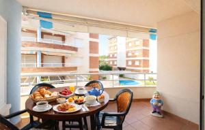 a table with food on top of a balcony at Gorgeous Apartment In Calafell With Swimming Pool in Calafell