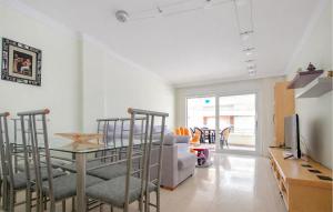 a living room with a table and a couch at Gorgeous Apartment In Calafell With Swimming Pool in Calafell