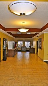 an empty lobby with a large room with a hard wood floor at Landmark Inn Fort Irwin in Fort Irwin