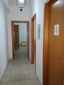 a hallway with two doors and a tile floor at Akron B&B in SantʼAlessio Siculo