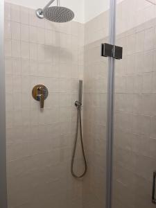 a shower with a shower head in a bathroom at CharmandView Assisi - vista unica su Basilica di Santa Chiara con terrazza panoramica esclusiva nel centro storico in Assisi +40 photos