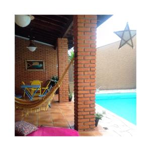 a house with a patio and a swimming pool at Black Hotel in Bauru