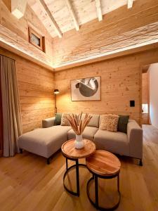 a living room with a couch and a table at Chalet Spatz Loft with Sauna Kandersteg Oeschinen Lake in Kandersteg
