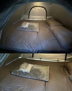 two beds in a tent with two pillows at Zulu land Kohlarn in Ko Lan