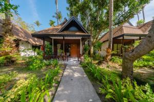a house with a pathway leading to the front door at Sand Sea Resort Railay Beach in Railay Beach