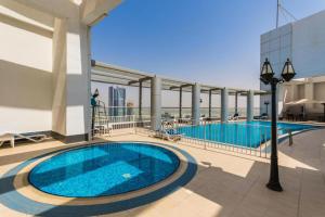 a swimming pool on the roof of a building at Downtown Dubai Mall walk & Burj Khalifa DIFC 5 mins in Dubai