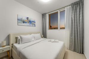 a white bedroom with a bed and a window at FIRST CLASS Villa Peaceful Pool View Retreat in Dubai +39 photos