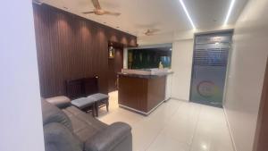 a living room with a couch and a bar at Sithara Grand in Ongole