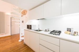 a white kitchen with a sink and a stove at Art Loft M8 Bari City Centre in Bari