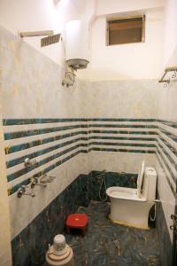 a bathroom with a toilet and a sink at Shri ram doot niwas in Ayodhya