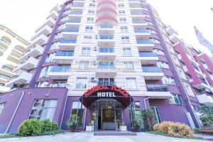 a hotel in front of a tall building at Admiral Plaza Hotel in Sunny Beach