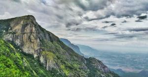 a view of a mountain on a cloudy day at Fogveilhomestay in Idukki