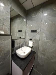 a bathroom with a sink and a mirror at White Panda hotels Shree Radhe in Dwarka