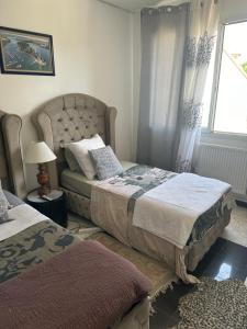 a bedroom with two beds and a window at Laila in Creil