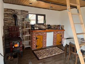 a kitchen with a brick oven and a table in it at Hill's Peak in Cacica