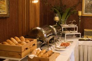 a table with boxes of bread on top of it at Grand Hotel & Spa Tirana in Tirana
