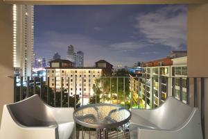 a balcony with a table and chairs and a city skyline at Naga Residence in Bangkok