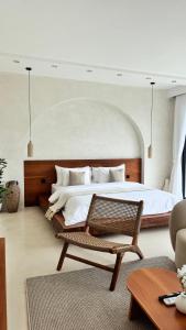 a bedroom with a large bed and a chair at Pinggan Foggy in Baturaja +45 photos