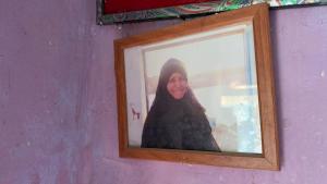 a woman standing in a mirror in a purple wall at Safeya Kato in Jazīrat ‘Awwāḑ