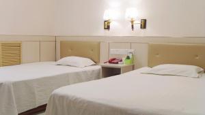 Ένα ή περισσότερα κρεβάτια σε δωμάτιο στο Qufu Garden Hotel
