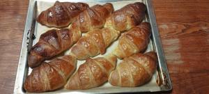 a tray filled with croissants on top of a table at Le Clos Joli 15 in Molompize