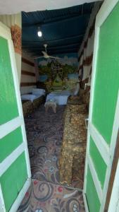 a room with green doors and a tile floor at Safeya Kato in Jazīrat ‘Awwāḑ