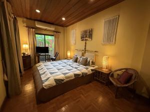 a bedroom with a large bed and a television at Saku Boutique Homestay in Saraphi +28 photos