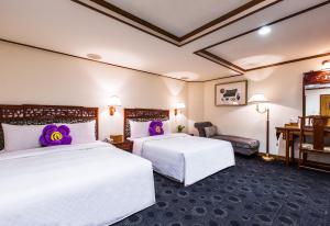 Postel nebo postele na pokoji v ubytování Han She Hotel