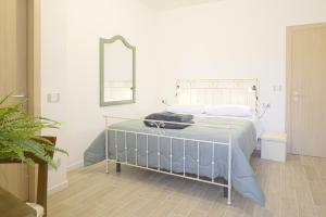 a bedroom with a bed with a mirror on the wall at Alloggio turistico Alla Vasca in Tregnago +12 photos